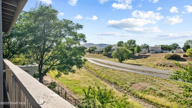 a view of staircase with white walls and white door