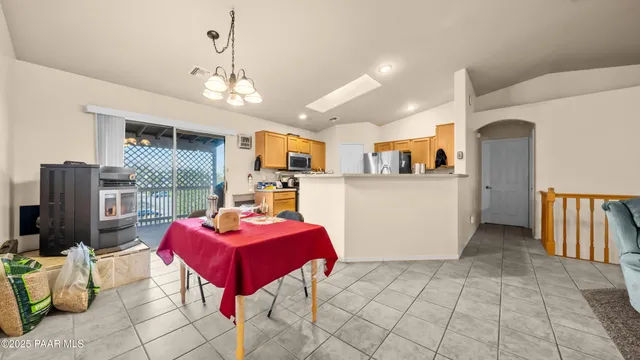 a view of a room with gym equipment and a chandelier