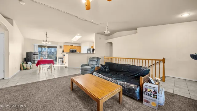 a bedroom with a bed and a ceiling fan