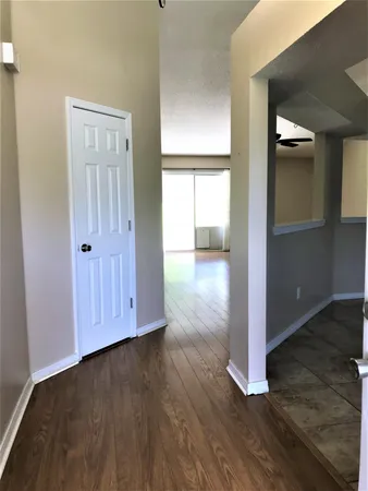 an empty room with wooden floor and closet