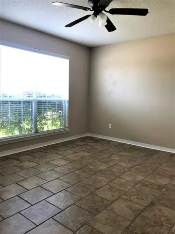 a view of an empty room and a window