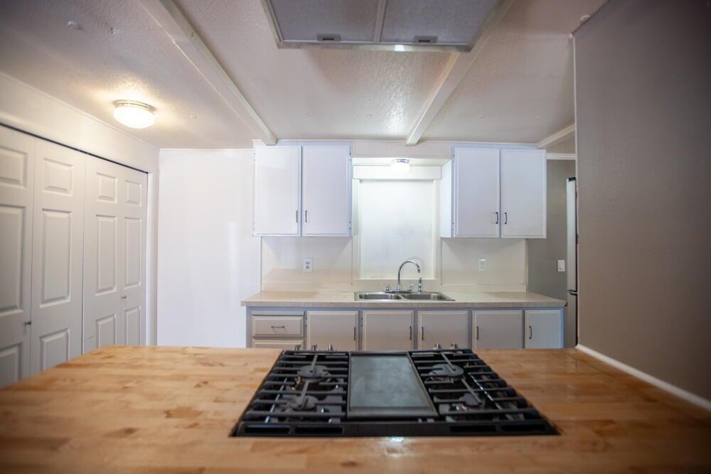 4778 North River Road Gold Hill, OR 97525 - Photo 4 of 15 a kitchen with sink stove and cabinets