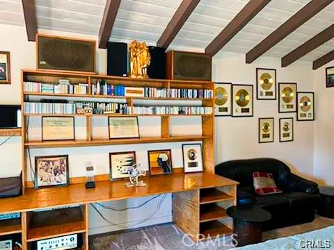 a living room with patio furniture and a floor to ceiling window