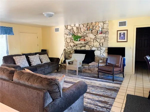 a living room with furniture a couch and a flat screen tv