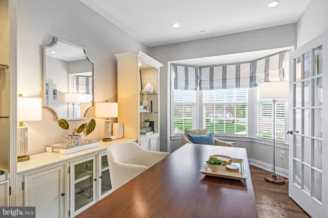 a kitchen with stainless steel appliances granite countertop a sink a stove a dining table and chairs