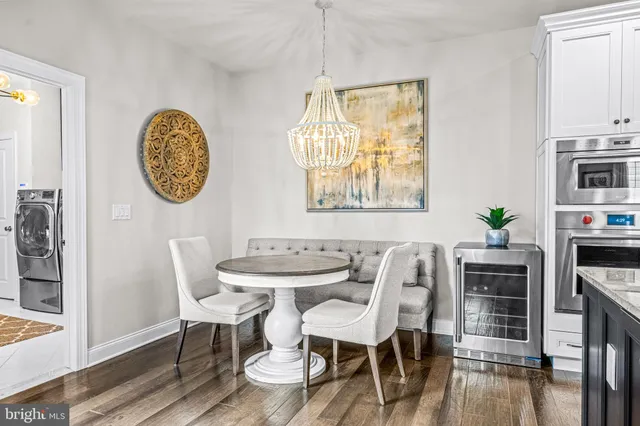 a view of a hallway with wooden floor and entryway