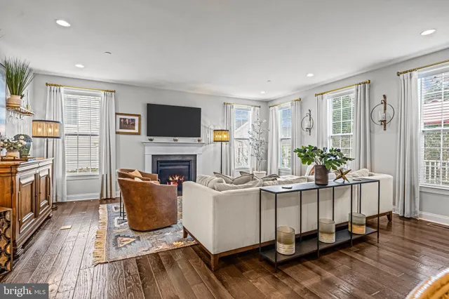 a bedroom with a bed a dresser and a large window