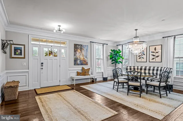 a living room with furniture a clock and a large mirror