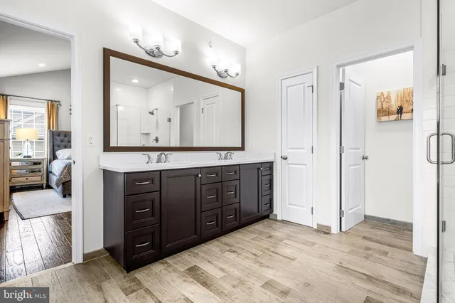 a bathroom with a toilet a sink and a mirror