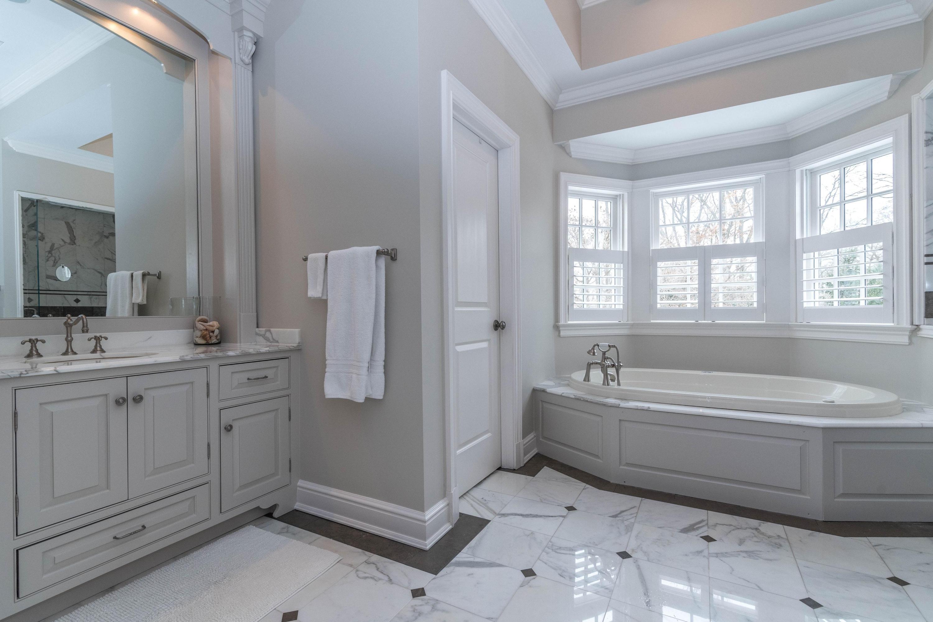 48 Leeuwarden Road Darien, CT 06820 - Photo 16 of 35 a spacious bathroom with a tub sink and mirror