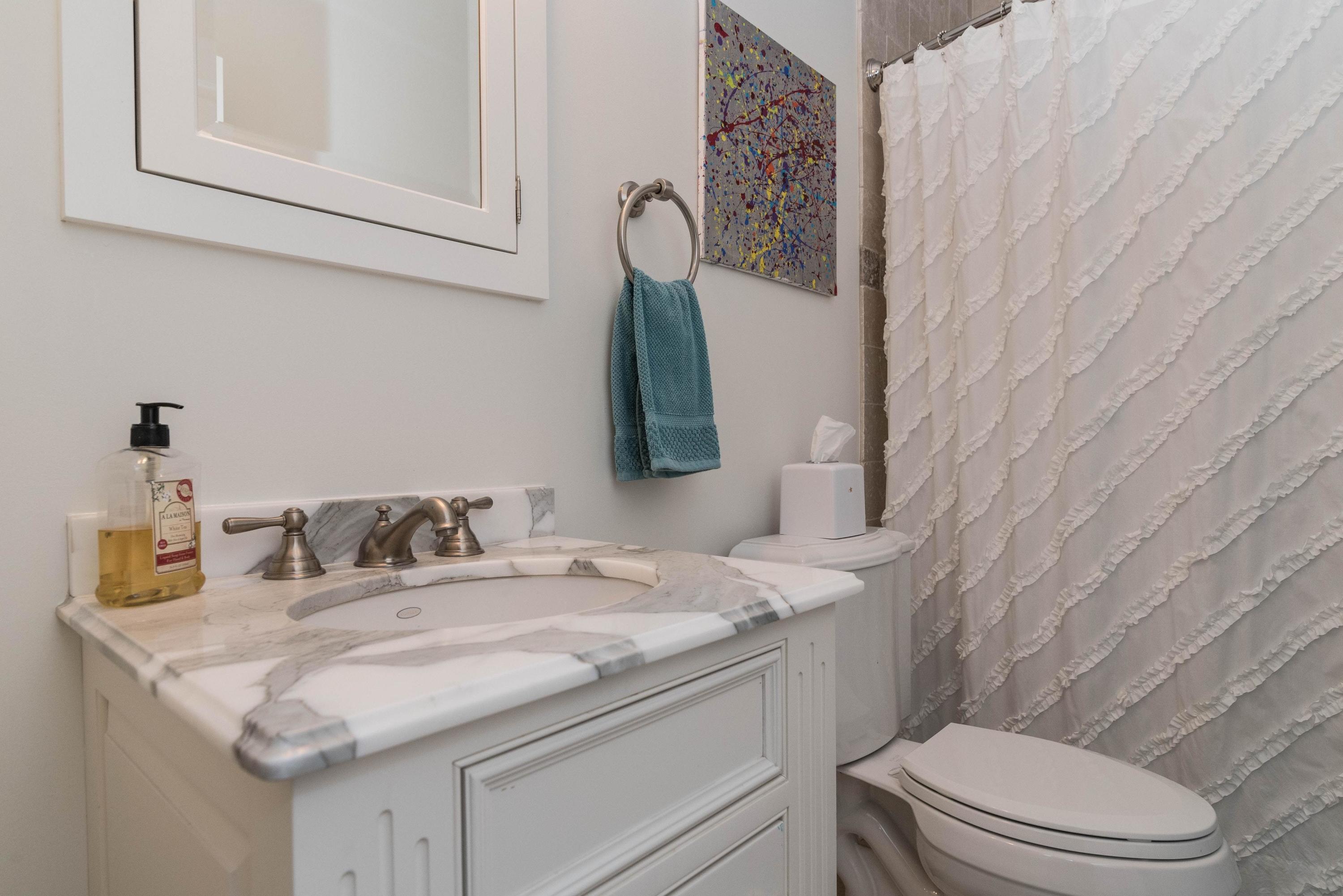 48 Leeuwarden Road Darien, CT 06820 - Photo 19 of 35 a bathroom with a granite countertop toilet sink and mirror