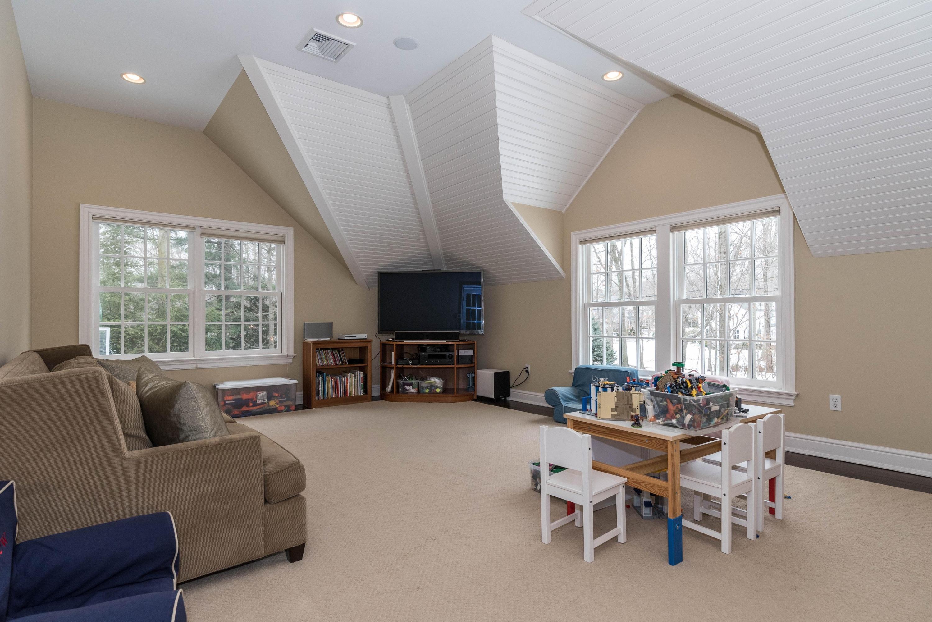 48 Leeuwarden Road Darien, CT 06820 - Photo 25 of 35 a living room with furniture and a flat screen tv