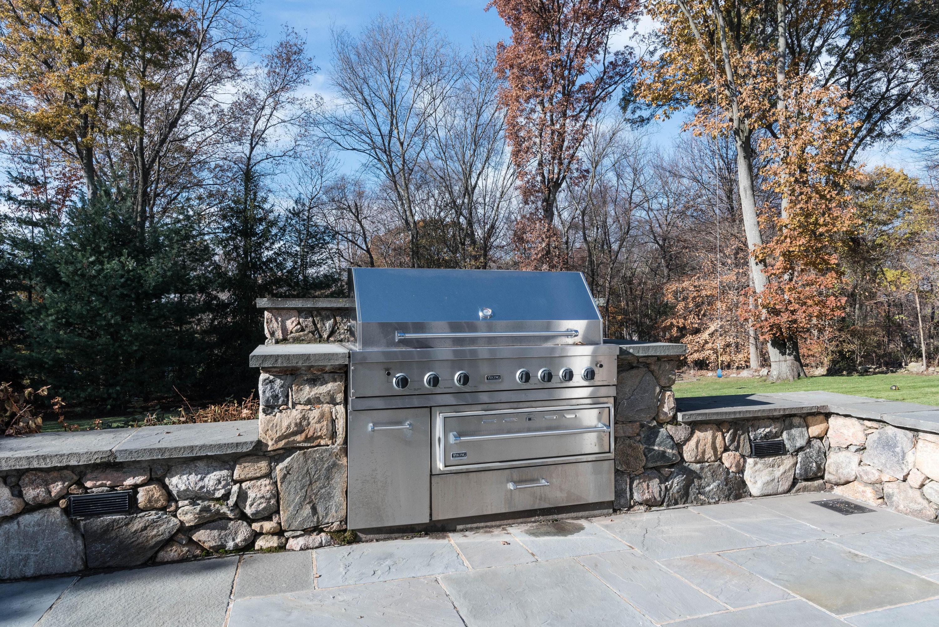 48 Leeuwarden Road Darien, CT 06820 - Photo 31 of 35 a view of a chairs and table in the back yard of the house