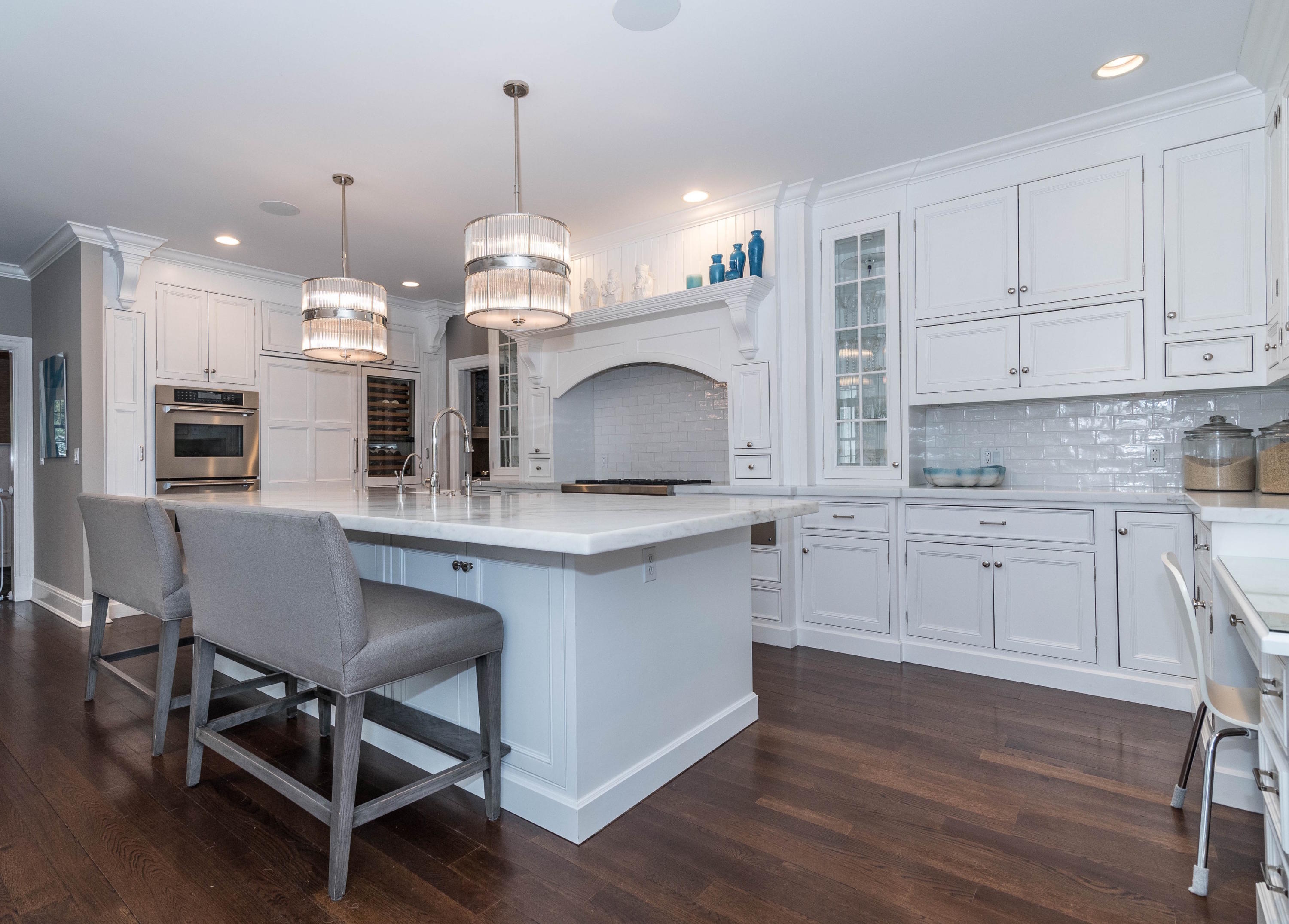 48 Leeuwarden Road Darien, CT 06820 - Photo 5 of 35 a kitchen with stainless steel appliances a dining table chairs sink and cabinets