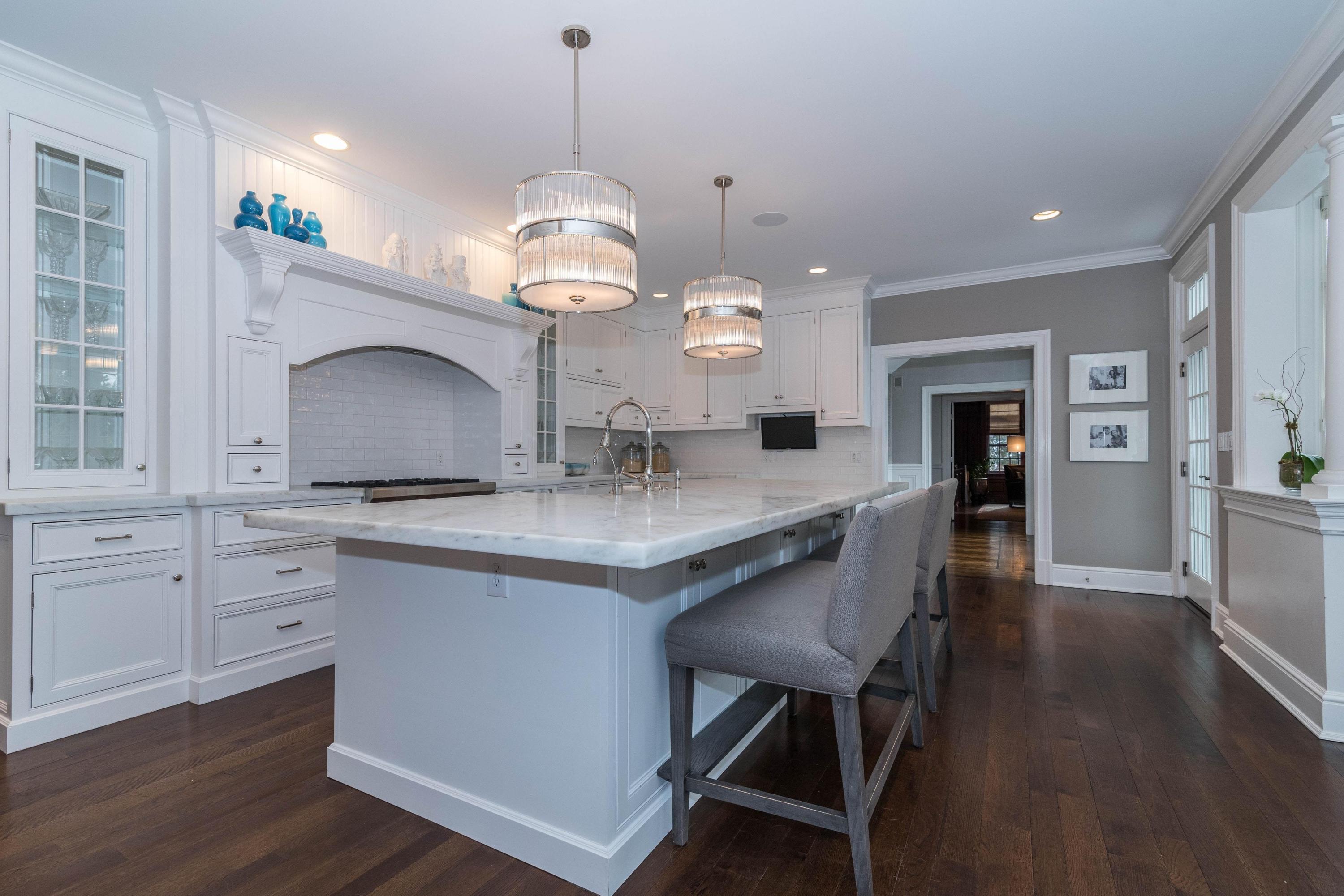 48 Leeuwarden Road Darien, CT 06820 - Photo 6 of 35 a large kitchen with granite countertop a stove oven a sink dishwasher and white cabinets with wooden floor