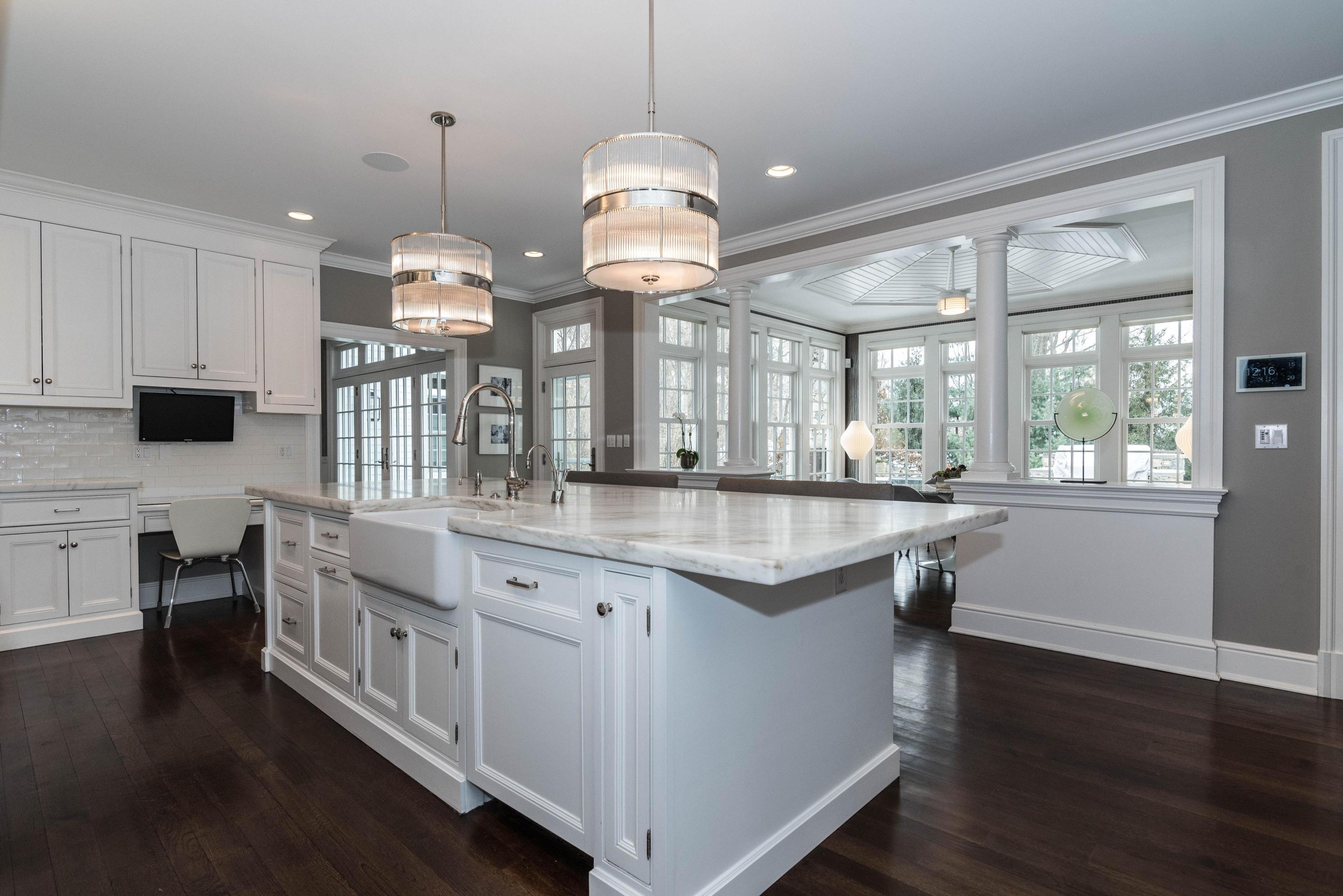 48 Leeuwarden Road Darien, CT 06820 - Photo 7 of 35 a kitchen with stainless steel appliances granite countertop wooden floors and white cabinets
