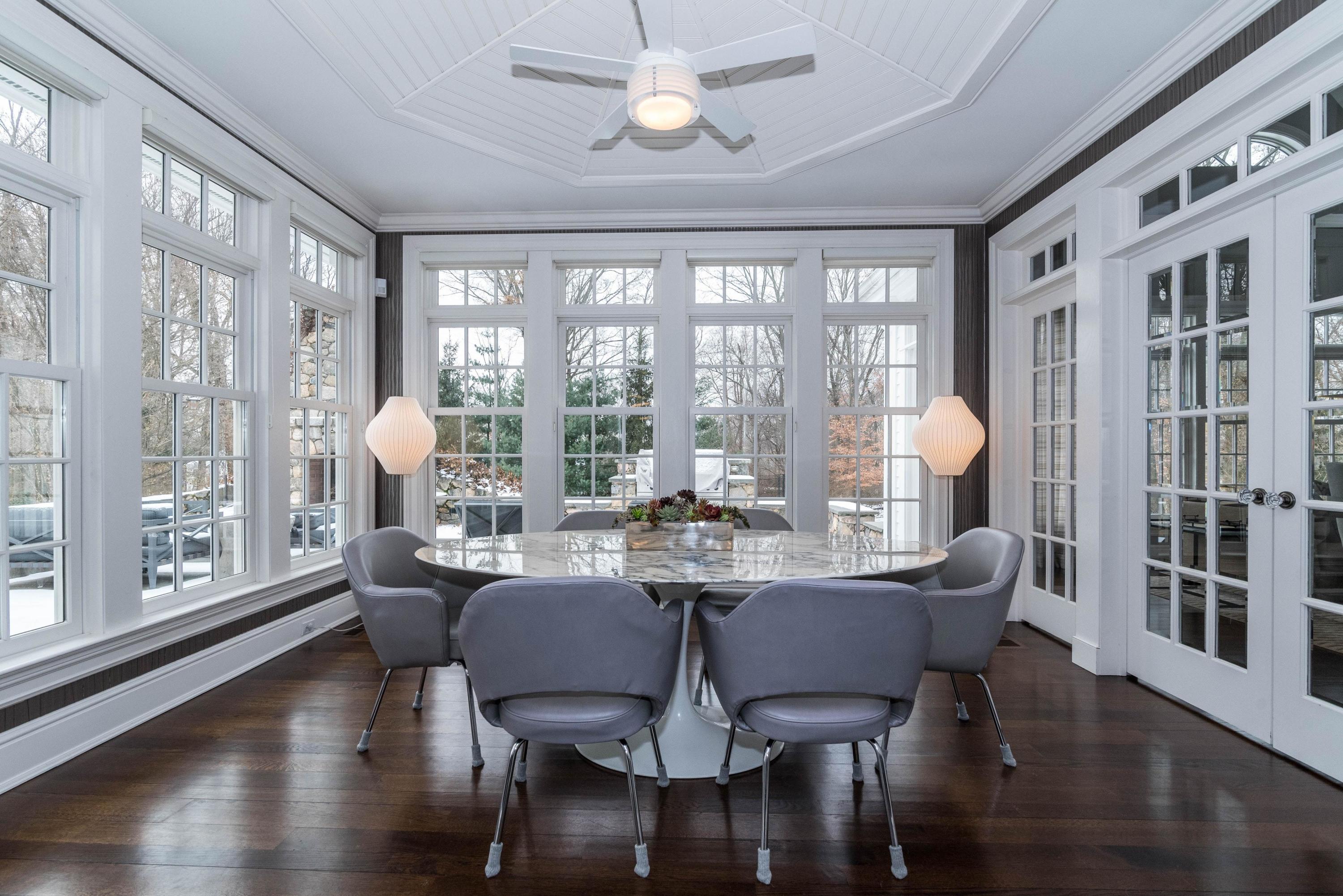 48 Leeuwarden Road Darien, CT 06820 - Photo 8 of 35 a view of a dining room with furniture large windows and wooden floor