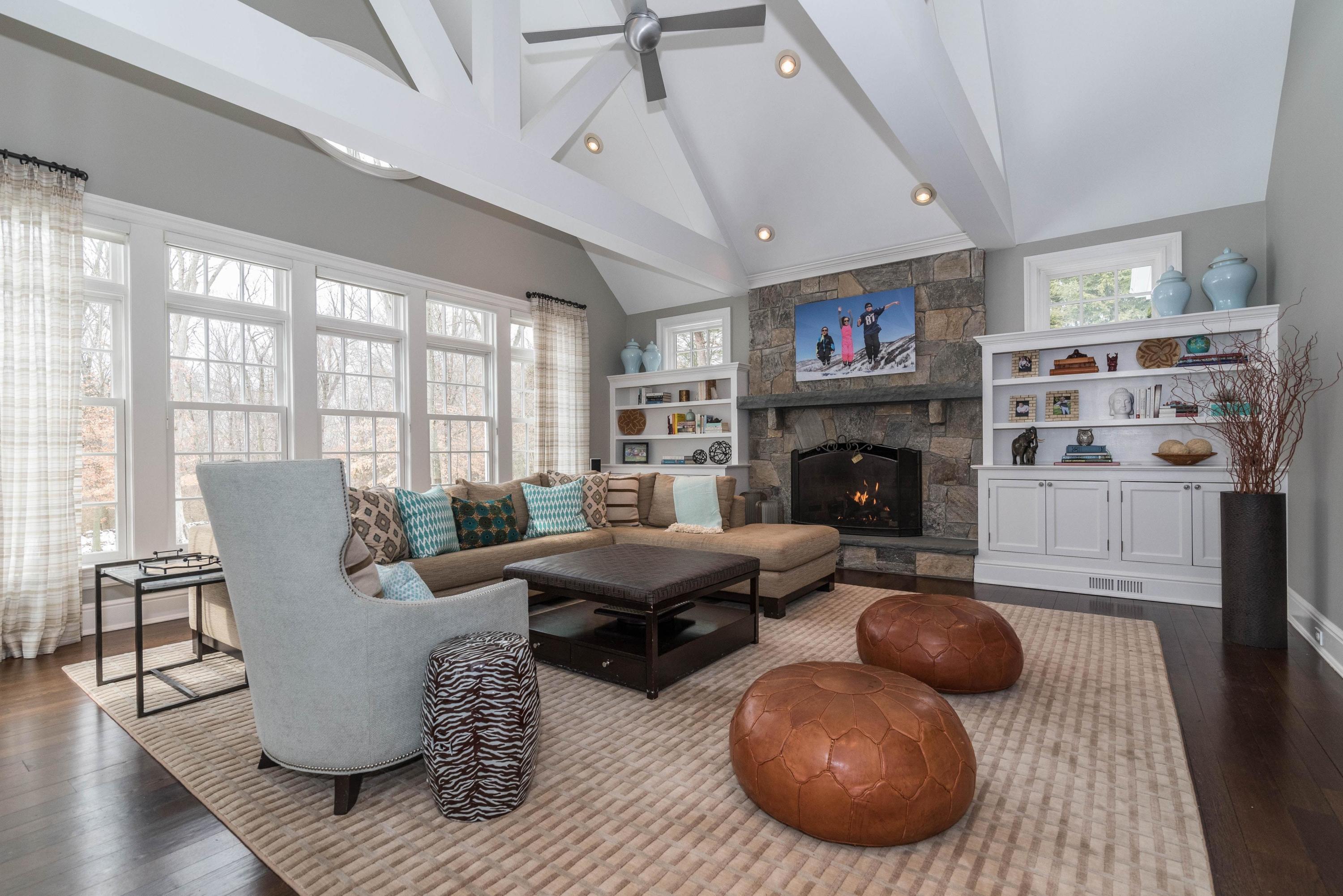 48 Leeuwarden Road Darien, CT 06820 - Photo 9 of 35 a living room with furniture a fireplace and a large window