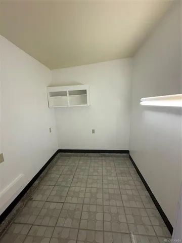 a view of a room with an empty space and a window