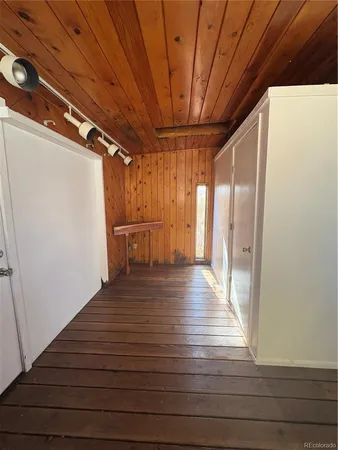 a view of a room with wooden floor