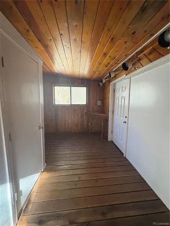 a view of hallway with wooden floor