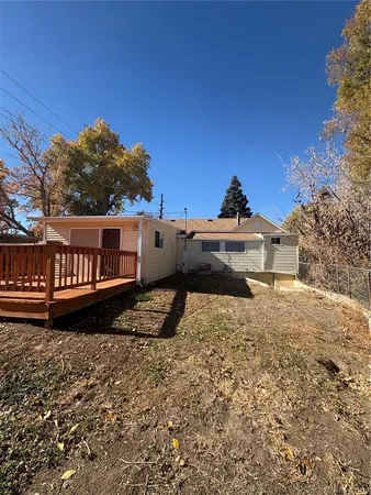 a view of a dry yard with wooden fence