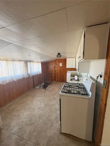 a kitchen with a stove and a refrigerator