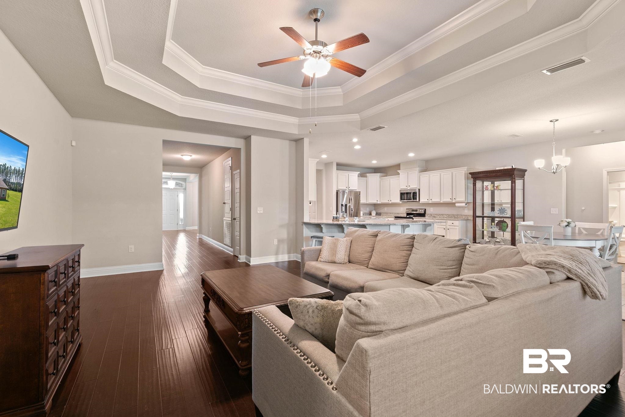 12750 B Jenkins Pit Road Daphne, AL 36527 - Photo 15 of 89 Living room featuring ceiling fan, dark wood finished floors, crown molding, and suspended lighting