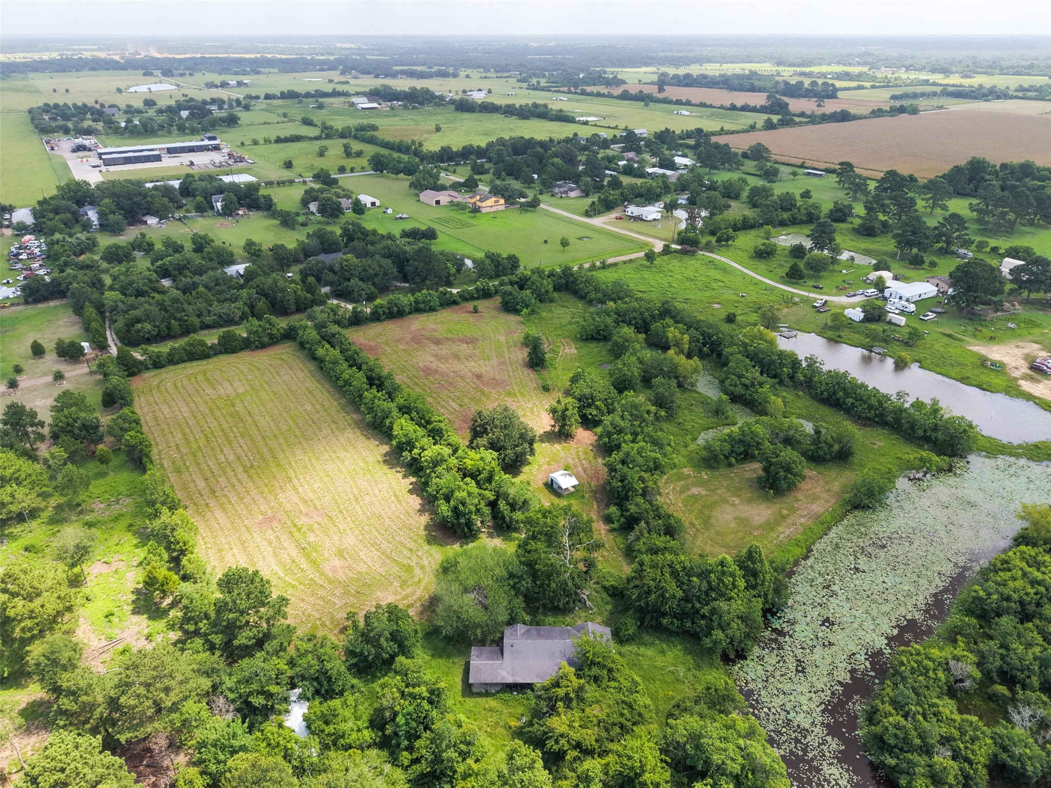 28619 Barry Lane Waller, TX 77484 - Photo 6 of 28 Expansive aerial perspective illustrating the property's layout, natural creek, open fields, and existing improvements.