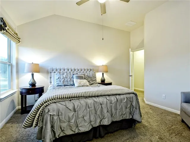 a bedroom with a bed and a lamp on table