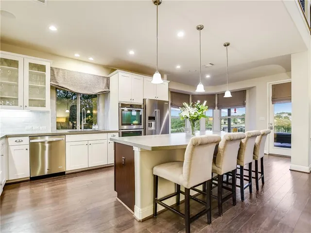 a large kitchen with a table and chairs