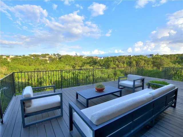 a view of a roof deck with couches and wooden floor