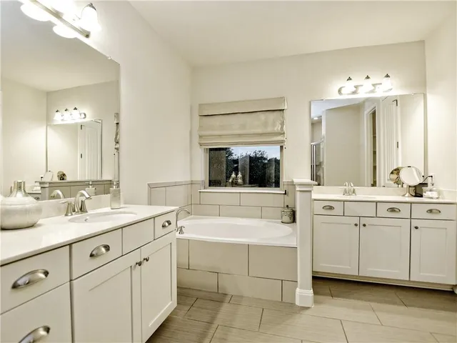 a bathroom with a sink vanity and mirror