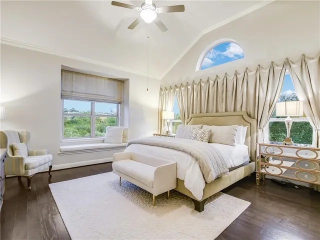 a spacious bedroom with a bed and a large window