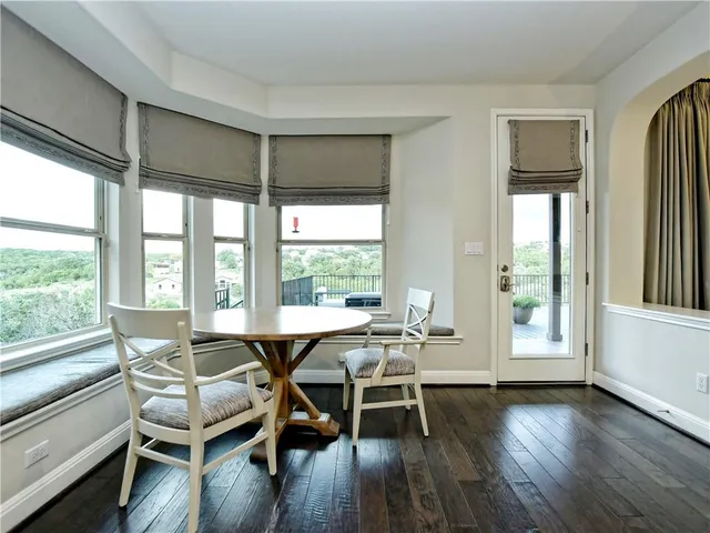 a dining room with furniture and wooden floor