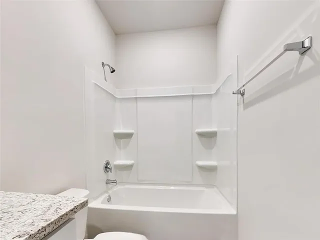 a view of house with backyard and wooden fence