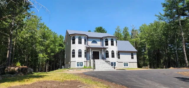 a front view of a house with a yard