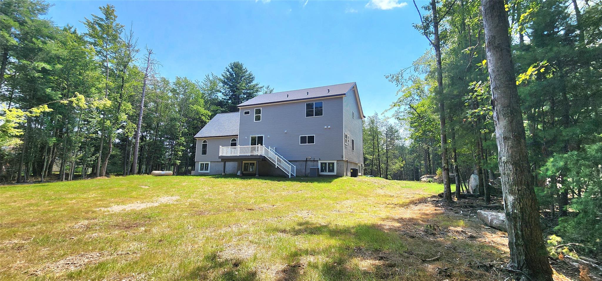 57 Haddock Road Monticello, NY 12701 - Photo 14 of 46 a view of a house with pool and trees in the background