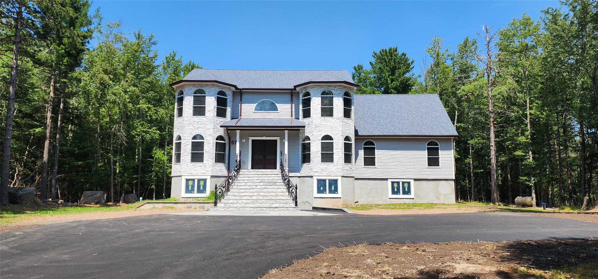 57 Haddock Road Monticello, NY 12701 - Photo 2 of 46 a front view of a house with a yard