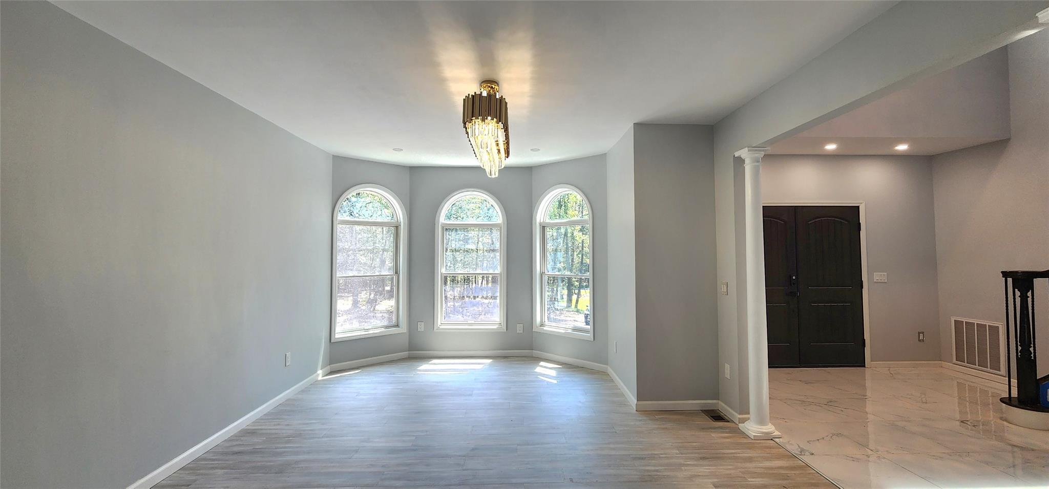 57 Haddock Road Monticello, NY 12701 - Photo 26 of 46 an empty room with wooden floor and windows