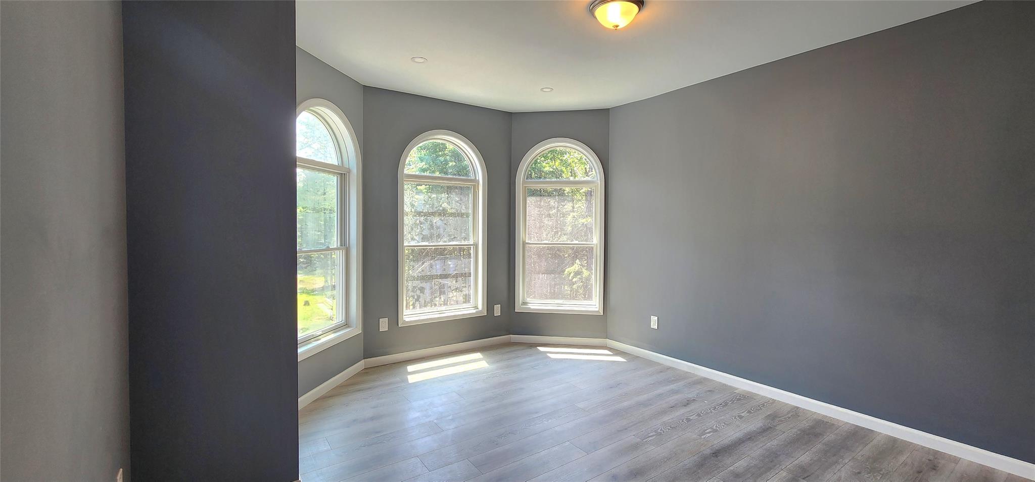 57 Haddock Road Monticello, NY 12701 - Photo 28 of 46 an empty room with windows and wooden floor
