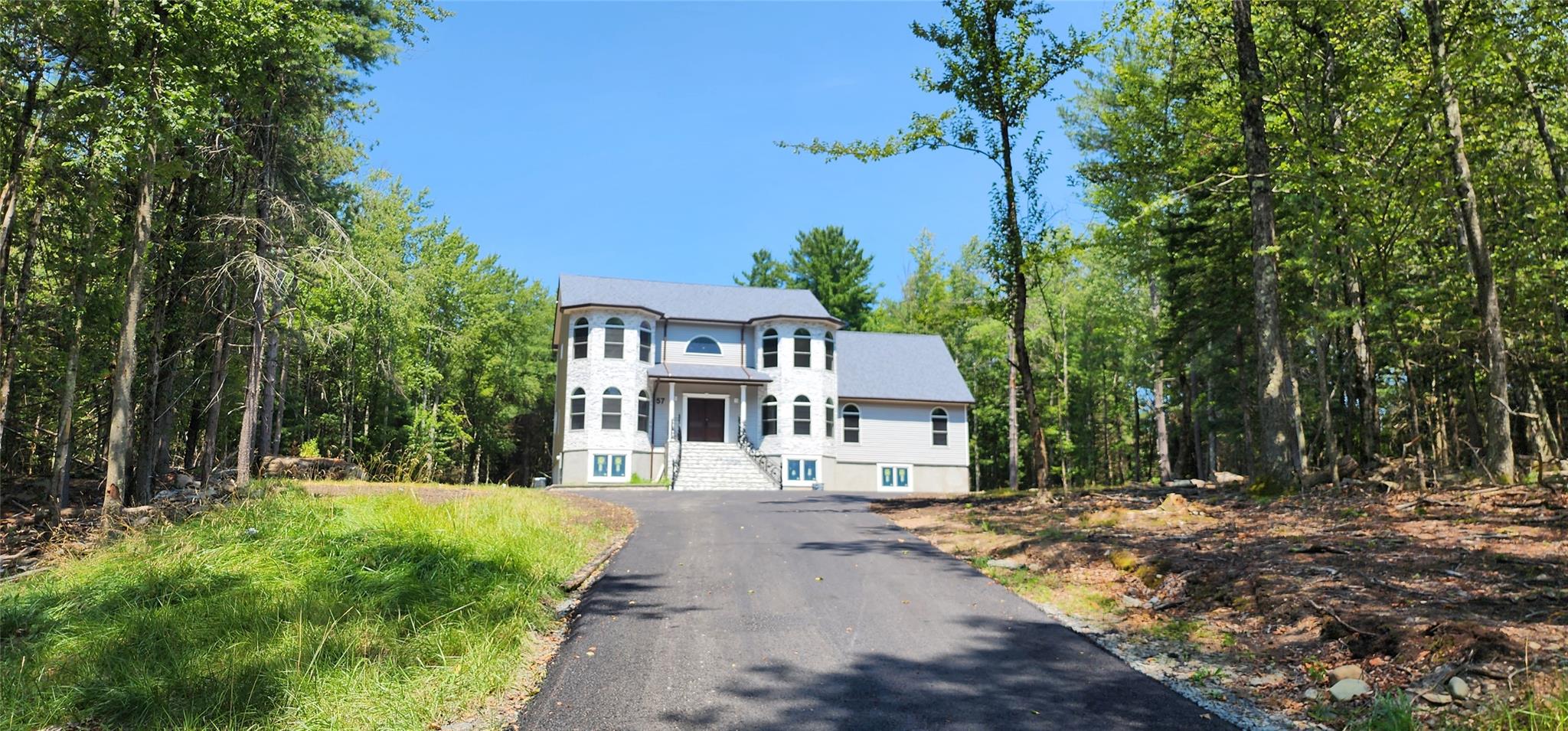 57 Haddock Road Monticello, NY 12701 - Photo 4 of 46 a front view of a house with a yard