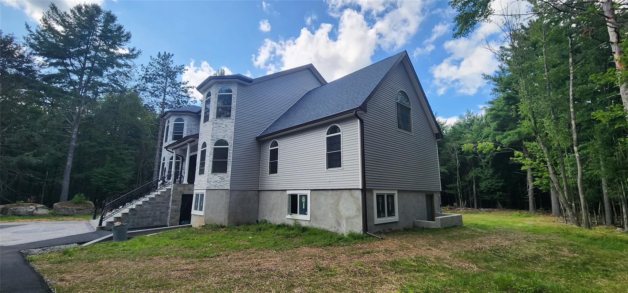57 Haddock Road Monticello, NY 12701 - Photo 6 of 46 a house that has a tree in front of the house