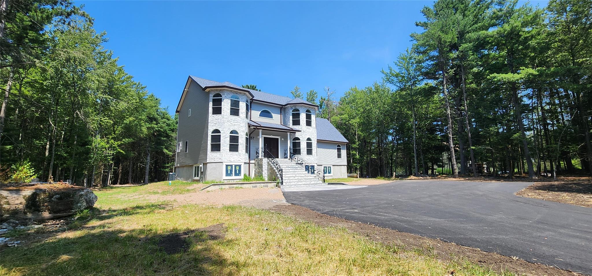 57 Haddock Road Monticello, NY 12701 - Photo 8 of 46 a front view of a house with a yard