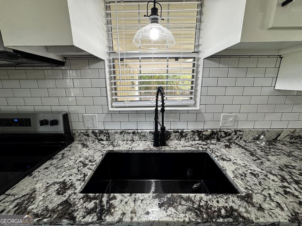 5781 Adams Road Valdosta, GA 31601 - Photo 12 of 27 a kitchen with sink and cabinets