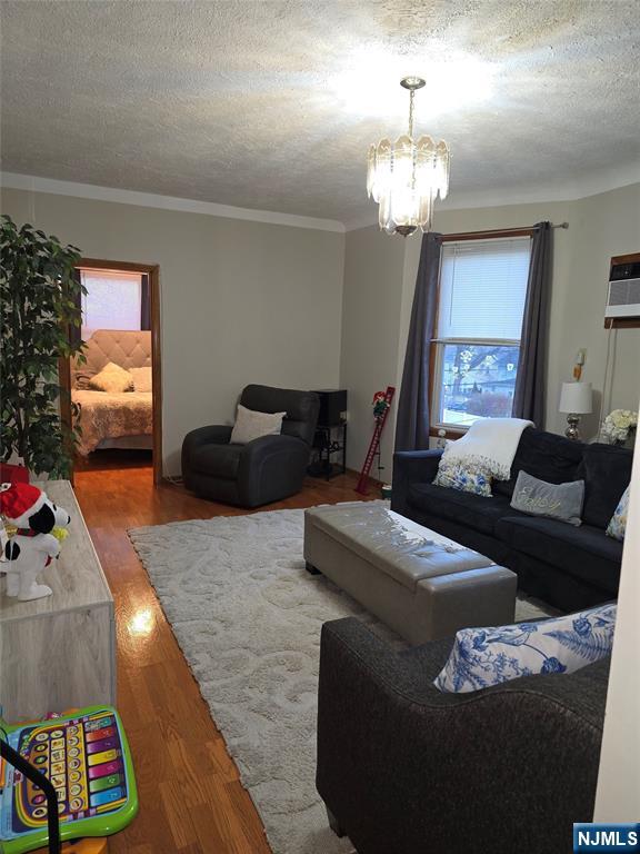 50 Columbia Avenue, Unit 2 Kearny, NJ 07032 - Photo 2 of 11 a living room with furniture and a chandelier