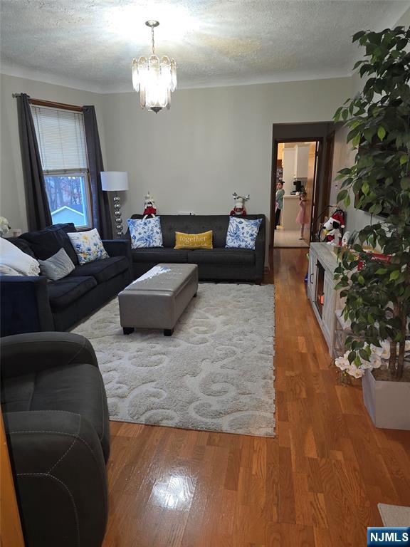 50 Columbia Avenue, Unit 2 Kearny, NJ 07032 - Photo 3 of 11 a living room with furniture and a chandelier