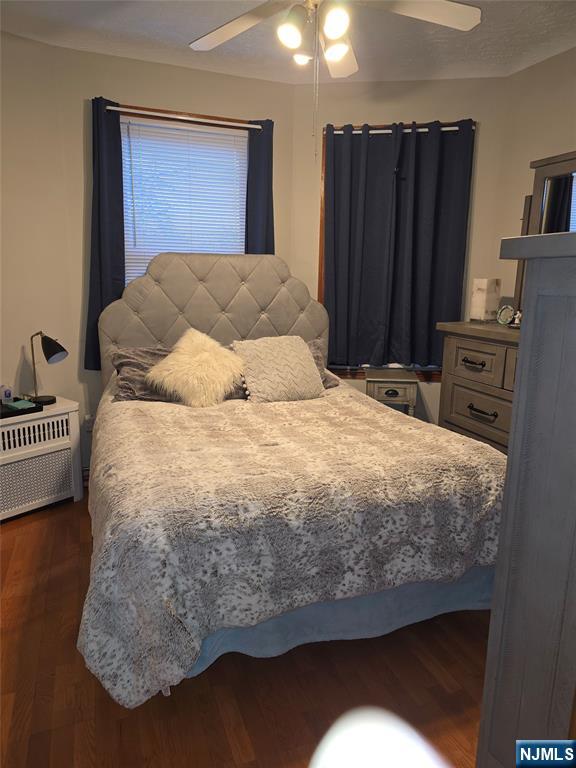 50 Columbia Avenue, Unit 2 Kearny, NJ 07032 - Photo 4 of 11 a bed sitting in a bedroom next to a cabinet and a lamp