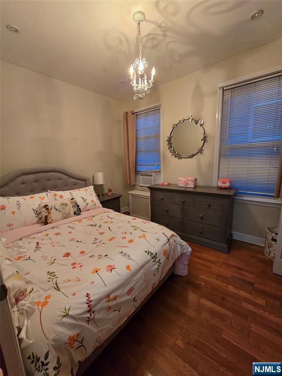 50 Columbia Avenue, Unit 2 Kearny, NJ 07032 - Photo 8 of 11 a bedroom with a bed and a chandelier