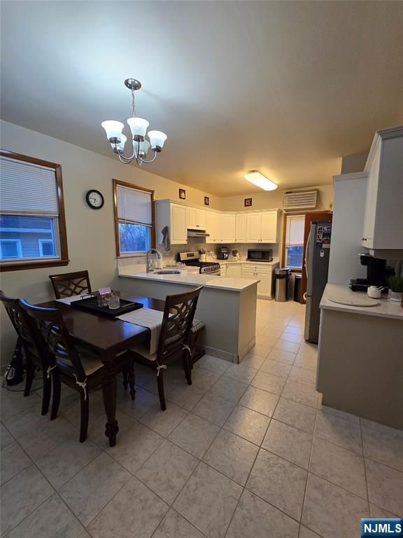 50 Columbia Avenue, Unit 2 Kearny, NJ 07032 - Photo 9 of 11 a view of a dining room with furniture and a chandelier